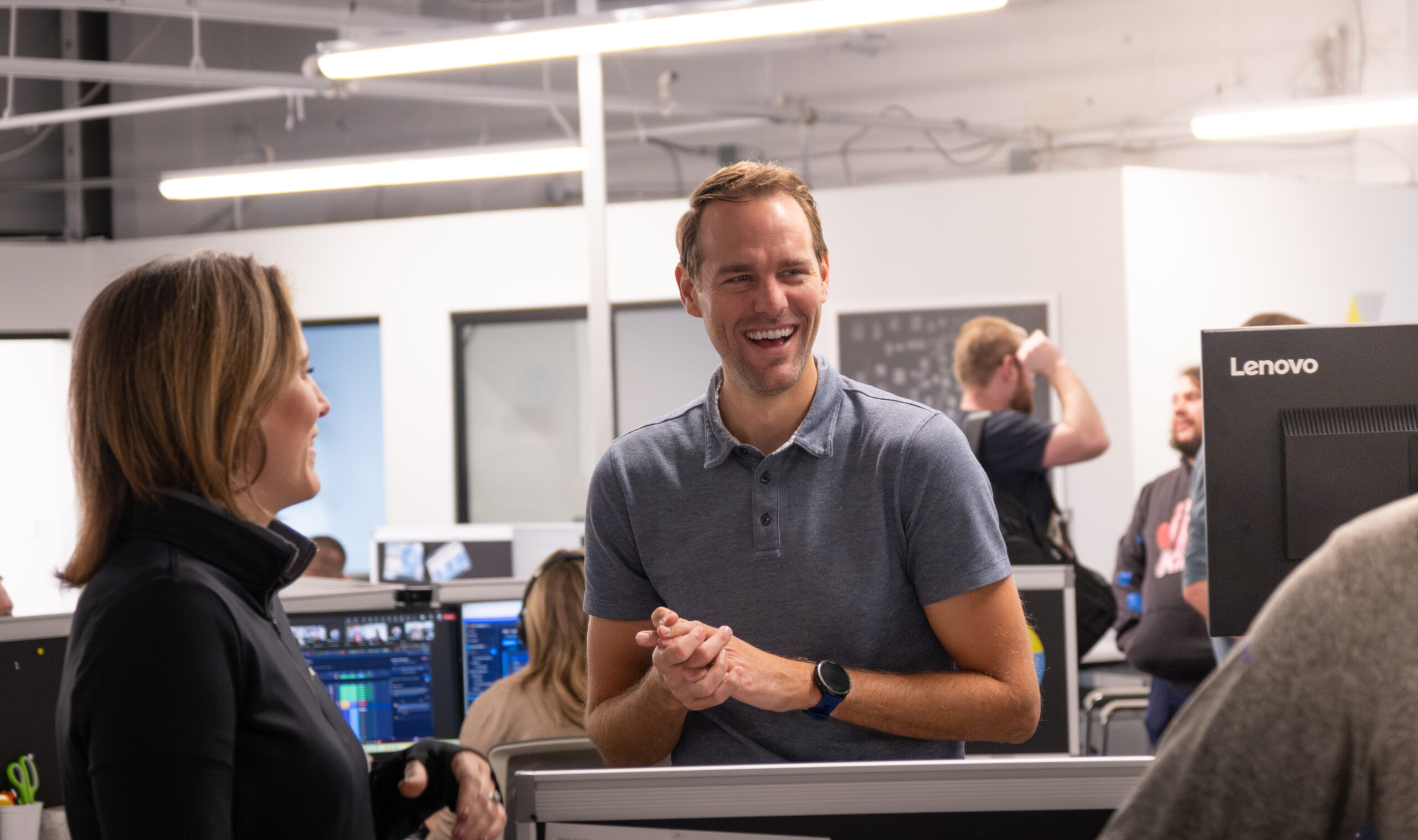 Account Managers Gathered Around a Computer Laughing