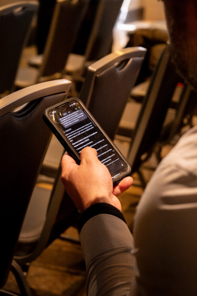 A hand holding a phone using Microsoft Copilot