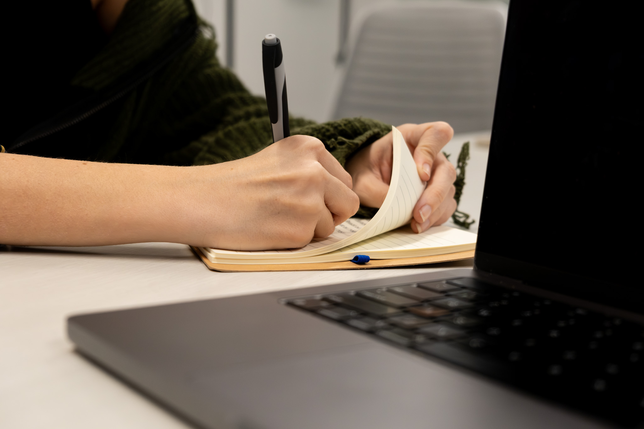 A women writing notes in a notebook.