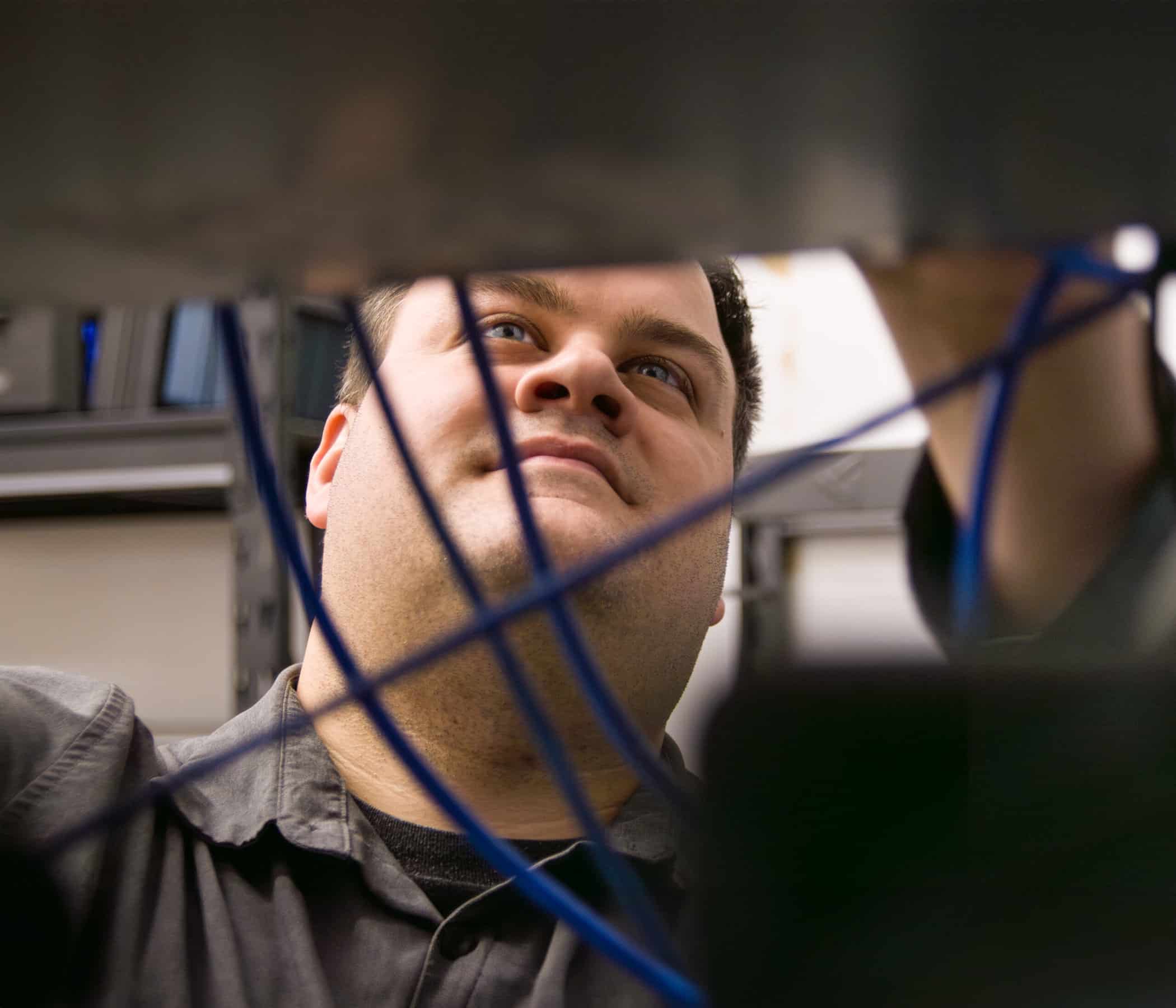 Project Manager adjusts wiring for servers.